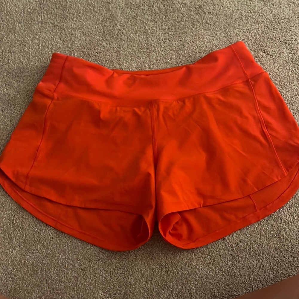 Solar orange lululemon shorts mid rise, 4 inch, size 8